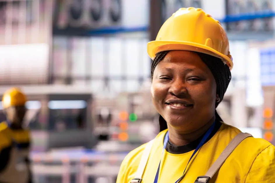 Optimized photo of a female blue collar worker in Ghana in yellow helmet.